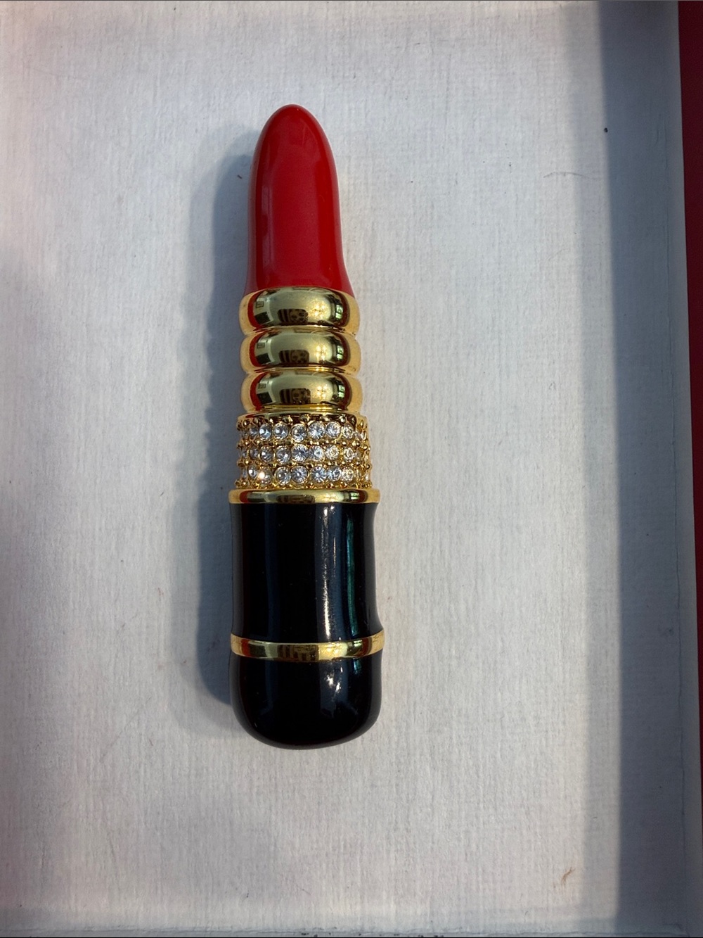 Luxury Red Lipstick Case with Gold and Black Accents